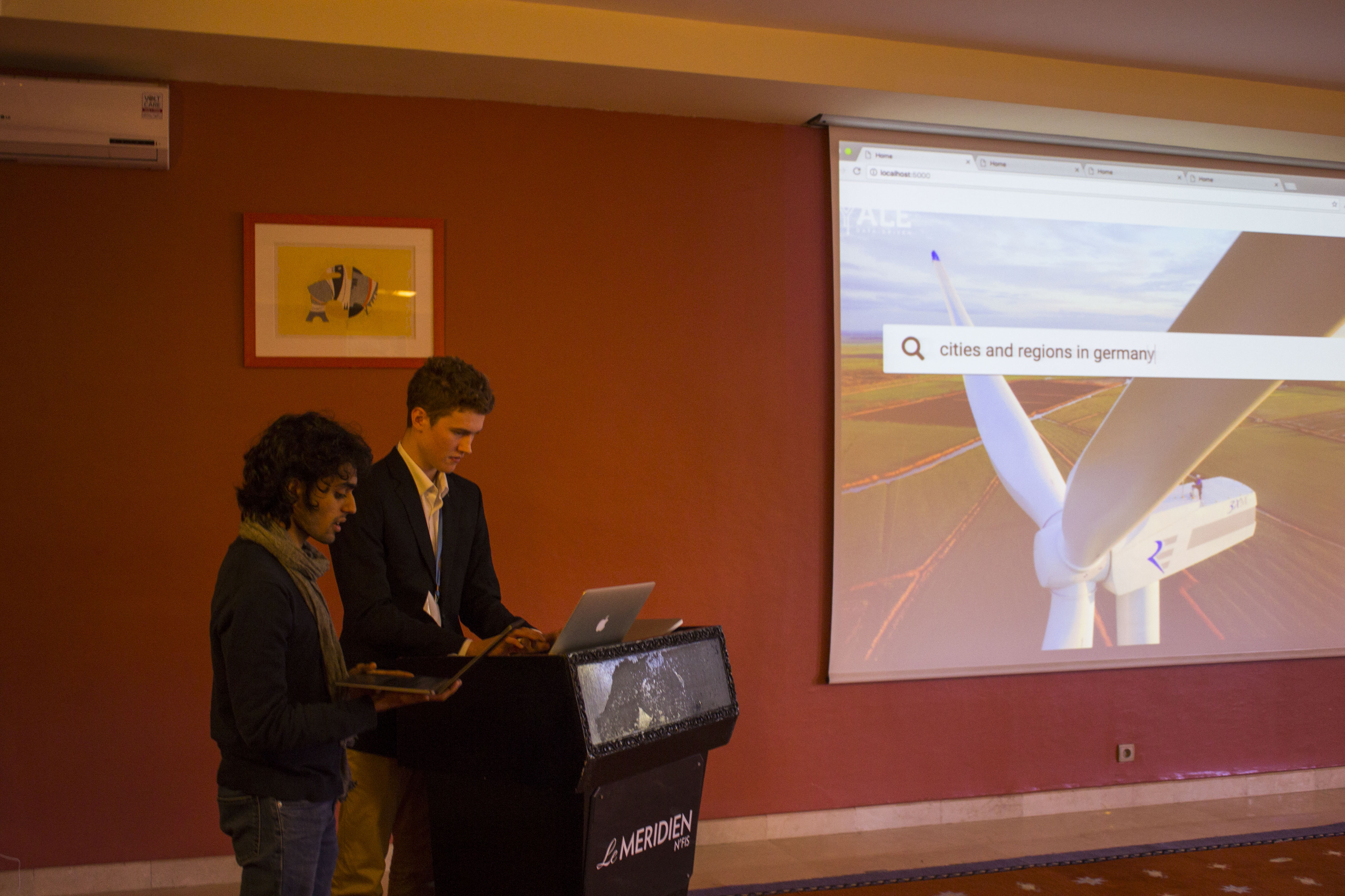 Data-Driven student researchers Aadit Gupta and Ross Rauber demo a new tool for exploring climate action commitments.