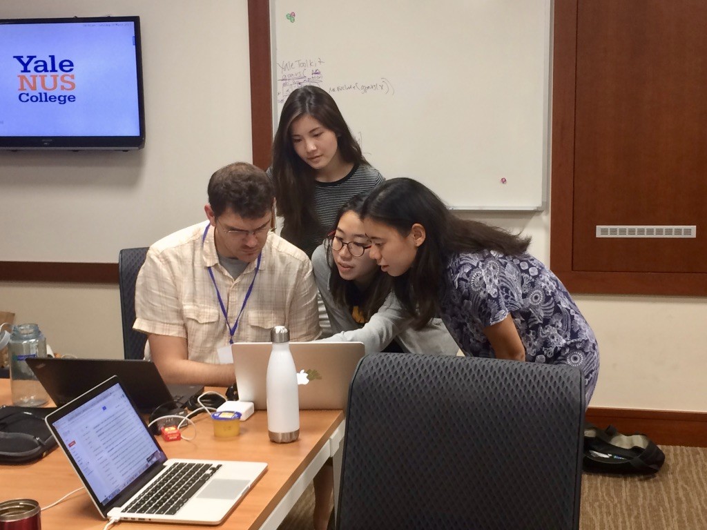 Ryan Thomas troubleshoots a question with Charis, Wyin and Jasmine of the Jia Peng Liao team. 