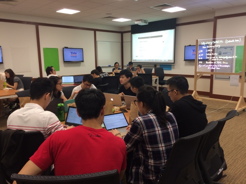 The hackathon begins, as teams discuss which data set they'll tackle. 